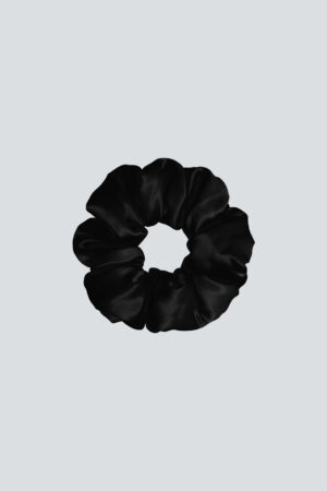 Donuts Large Silk Scrunchie in black creates a sleek finish while protecting strands from friction damage.