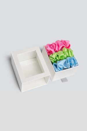 3 Pack Large Silk Scrunchie Set in bright pink, lime green, and sky blue, adding a vibrant, silky touch to your hair routine.