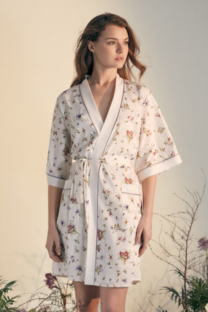 Woman in Lrisettet Silk Short Kimono with elegant floral print and waist tie.