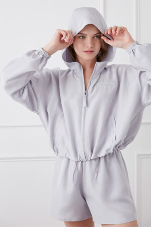 Woman wearing Athflow women's sun protection hoodie set with hood up.