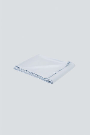 Neatly folded MANITO Authentic Silk Flat Sheet in light blue, highlighting fine stitching.