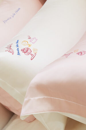 Detailed View of Canelé Pink Mulberry Silk Duvet Cover surface, highlighting the artistic dessert-inspired embroidery.