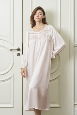 Woman in Dream Women's Nightdress stands gracefully by a door, showing the flowing silhouette and relaxed fit of the silk fabric.
