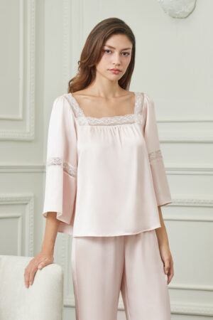 Close-up of MANITO Dream Women's Pajama Set featuring lace-trimmed square neckline and flowing sleeves in soft pink silk.