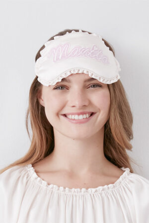 Model wears MANITO Fairy Silk Eye Mask with ruffle trim, showcasing soft silk comfort and elegance.