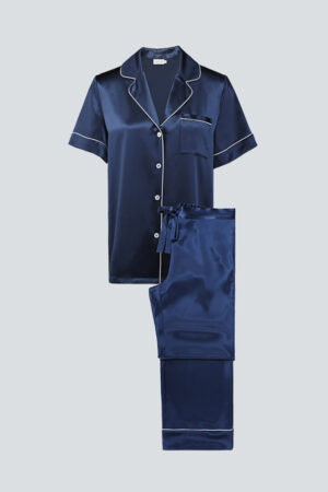 Flat lay of navy MANITO Authentic Short Sleeve Pajama Set with classic collar and ivory trim.