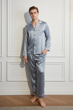 Model in silver MANITO Fragment Men's Pajama Set with long-sleeve silk shirt and relaxed pants.