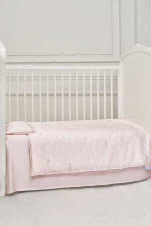 Pink Alice Daisy Children Bedding Sets neatly laid on a white kid's bed with daisy motifs, creating a gentle sleep scene.