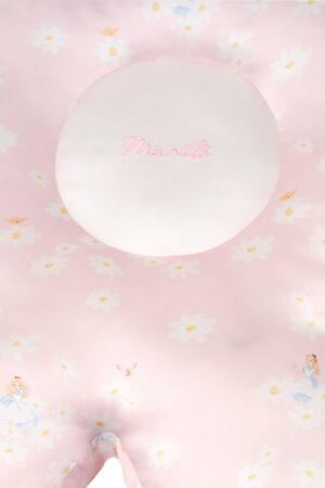 Close-up of pink MANITO Daisy Flower Pillow showing the embroidered logo and daisy patterns on smooth silk.