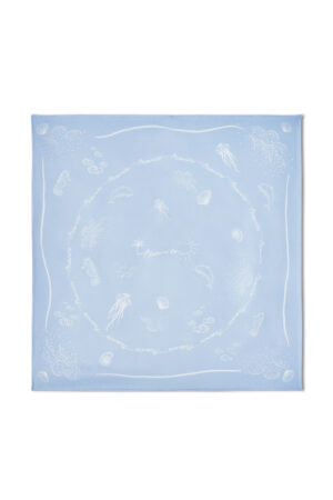 Zoomed-in detail of jellyfish print and marine elements on MANITO Ocean Blue Silk Scarf's delicate weave.