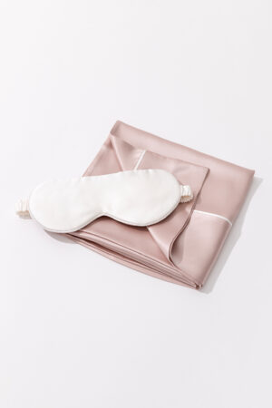 Luxurious MANITO Silk Pillowcase with Matching Eye Mask in Dusty Rose on a White Background.