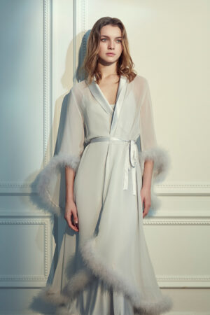 Woman in MANITO Diva Feather Trimmed Long Robe with hand-stitched feather trim.