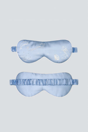 Front and back views of MANITO Ocean Blue Silk Eye Mask with marine embroidery details.