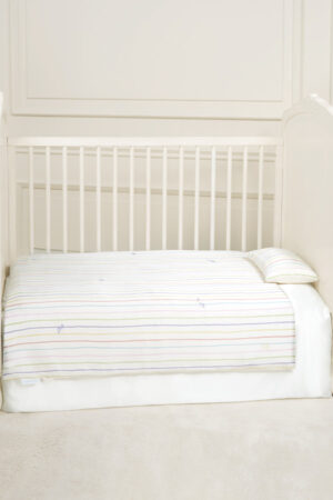 MANITO Ocean Stripe baby crib bedding set displayed in a white crib.