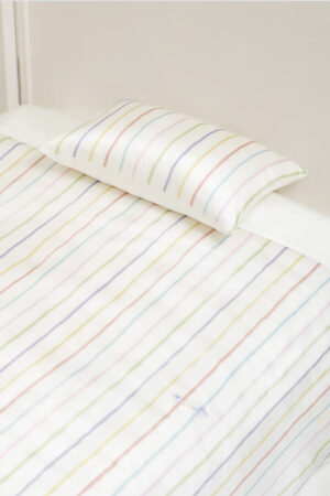 Close-up of MANITO Ocean Stripe baby crib bedding set with a silk pillowcase.