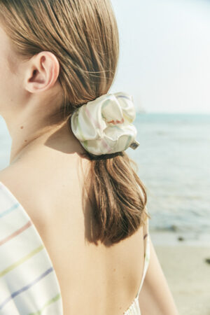 Model wearing the MANITO silk scrunchie with colorful stripes, adding a soft and elegant touch to the hairstyle.