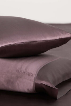 Plum purple silk pillowcase set with signature MANITO embroidery for a touch of elegance.
