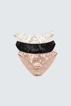 Three stacked silk briefs in white, black and pink with 'Honest,' 'Glamour,' and 'Felicity' embroidered, Blithe Gift Box.