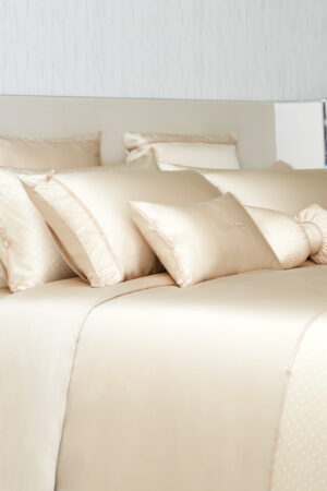 Side view of a neatly arranged bed covering MANITO Ribbon Silk bedding sets.