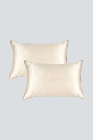 A set of two MANITO Ribbon Silk Pillowcases, featuring a timeless polka dot pattern and elegant ribbon details.