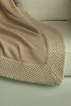 Close-up of Sand Dune Knit Throw Blanket edge, highlighting its fine knit border and cozy woven texture.