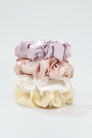 Four Thick Silk Scrunchies stacked to show plush ruffles and a soft, hair-friendly hold.