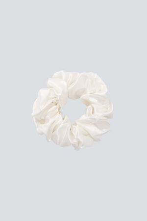 The Ivory Thick Silk Scrunchie adds a clean, refined touch while keeping your hair smooth.
