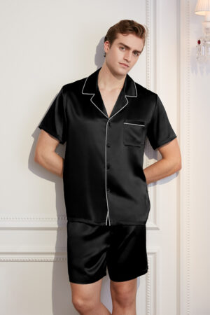 Stylish man posing in a Men's Short Black Silk Pajama Set with contrast piping.