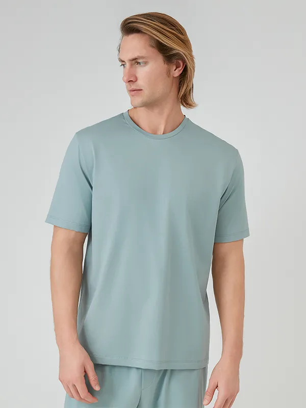 A display of MANITO's silk sleepwear collection, featuring luxurious pajamas and robes.