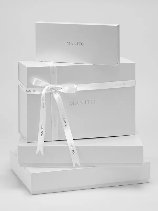 MANITO's premium gift packaging featuring a silk ribbon and branded box.