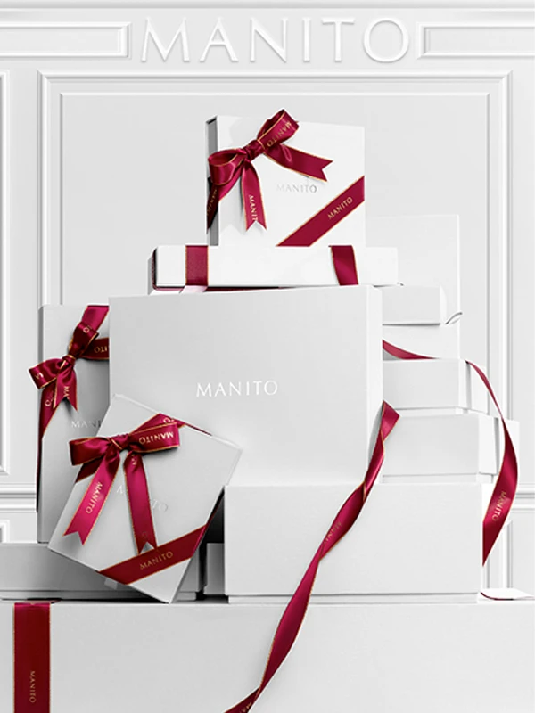 Stacked MANITO gift boxes with satin ribbons, exuding luxury, perfect for cherished occasions.